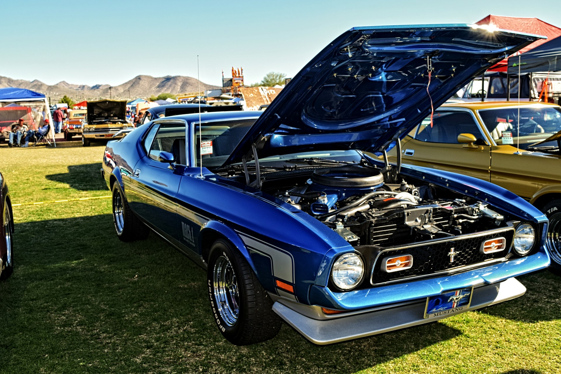 Blue classic Ford Mustang showcasing the kinds of cars to be displayed at the Pebble Beach Concours d'Elegance, showcasing automotive excellence and elegance, with Woodside Credit providing financing solutions for classic and collector cars at the event.
