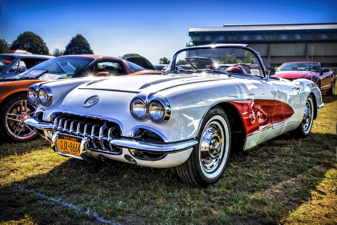 Classic white and red convertible car on display at a car show, showcasing vintage automotive design and engineering, perfect for classic car enthusiasts and collectors. Woodside Credit offers financing solutions for classic cars like this one.