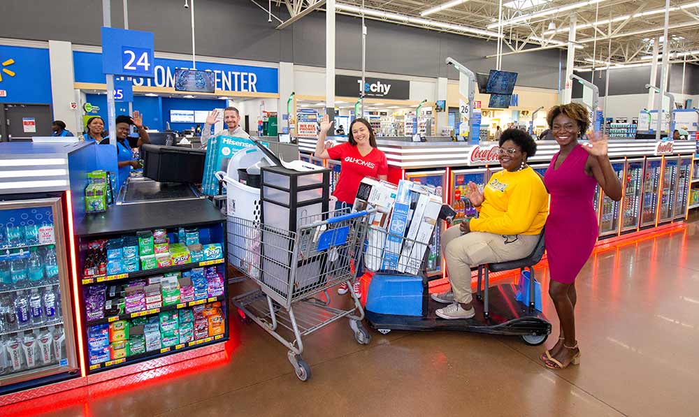 Johane Saintil, assisted by GL Homes VP/Project Manager Dianna Betancourt and Youth Haven Gift Officer Wotts Mercy, smiles during a college dorm shopping trip at Walmart in Naples. The event, part of GL Homes' Good Night's Sleep initiative, provided $2,500 worth of essential items for Johane's move to Florida International University.